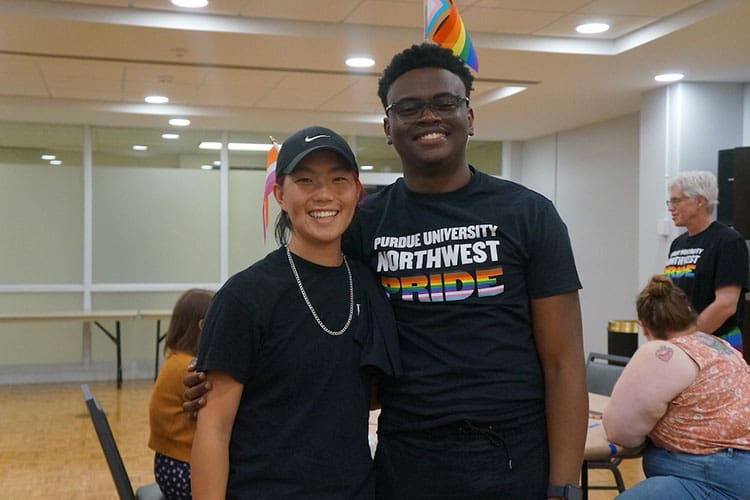 Two students stand together during pride fest