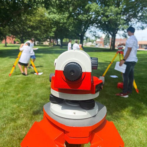 Campers operating surveying equipment